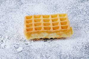 Square waffle on powdered sugar