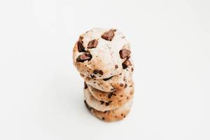 Stack of homemade chocolate chip cookies, vegan on white background