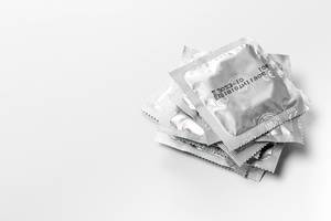 Stack of sealed condoms on a white background (Flip 2019)