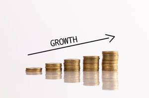 Stacks of coins with growth text