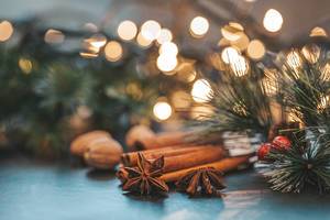 Star anise, cinnamon and nutmeg on Christmas night background with Golden bokeh