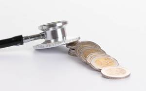 Stethoscope with 2 Euro coins on white background