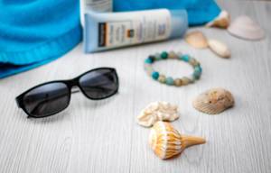 Summer Background with Shells, Bracelet, Sunglasse and Sunscreen