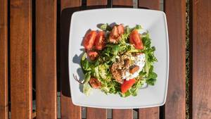 Summer salad with mangel, tomatoes, fresh cheese, almonds and flaxseed
