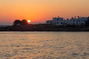 Sunset with red sky over the Greek harbour town Naousa on Paros in the Mediterranean Sea