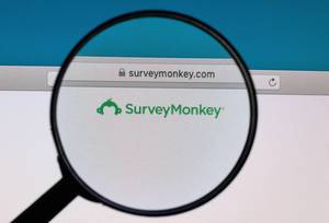 SurveyMonkey logo under magnifying glass
