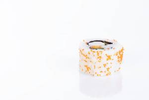 Sushi roll filled with green pepper and cooked shrimp with sesame seeds in white background