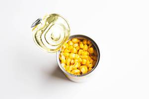 Sweet corn in a can on white background