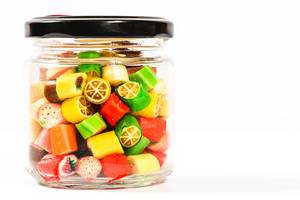 Sweet fruit candies in a glass jar