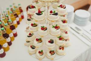 Sweet White Mini Cakes On A Transparent Stand