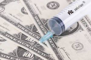 Syringe with American dollars banknotes
