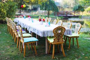 Table and chairs arranged for outdoor children party