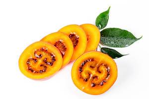 Tamarillo sliced and half on white background with leaves (Flip 2020)