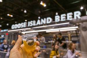 Tasting American craft beer Goose Island served in small plastic cups at a special stall in Chicago