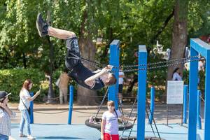 Teenage boy on a swing in Gorky Park