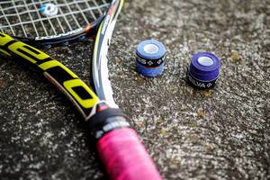 Tennis racket and over grip rolls