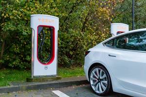 Tesla Aufladestationen unbenutzt und benutzt auf einem Parkplatz