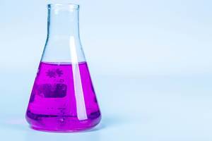 Test flask with purple liquid on light background