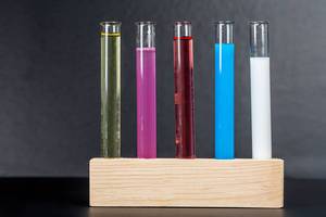 Test tubes with colorful liquids on black background (Flip 2020)