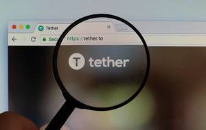 Tether logo on a computer screen with a magnifying glass