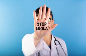 Text Stop Ebola in the palm of doctors hand