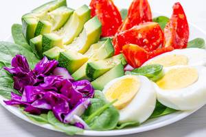 The concept of dietary nutrition. Boiled eggs with fresh vegetables (Flip 2019)