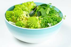 The concept of healthy diet food. Salad with avocado, romanesco cabbage and watercress