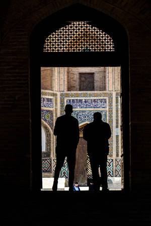 The Mir-i-arab Madrassah seen beyond the doors of the Kalon Mosque, Bukhara, Uzbekistan (Flip 2019)
