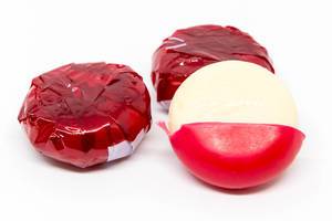 The pieces of Red Babybel Cheese on White Background