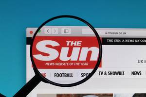 The Sun logo under magnifying glass