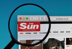 The Sun website under magnifying glass