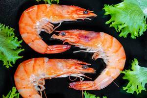 Three large prawns with lettuce leaves