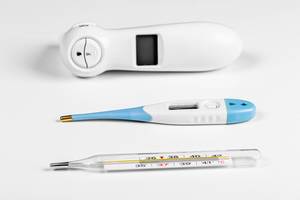 Three types of thermometers for measuring body temperature in a patient on a white background