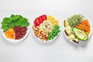 Three variants of diet lunch on a white wooden background. Top view (Flip 2019)