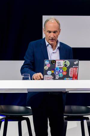 Tim Berners-Lee,  World Wide Web co-founder on stage with his notebook at Digital X