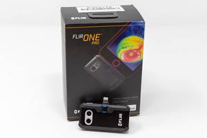 Tiny thermal imaging camera FLIR ONE Pro LT for Android devices, in front of the dark packaging box