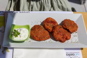 Tomato "keftes" with spring onions, fresh herbs and feta cheese, served with soft cheese "katiki" of Domokos