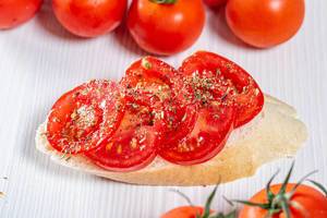Tomato sandwich on white wooden background