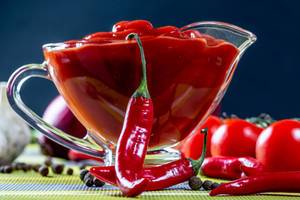 Tomato sauce in glass gravy boat with Chile