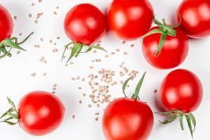 Tomato seeds and fresh tomatoes on a white background (Flip 2020)