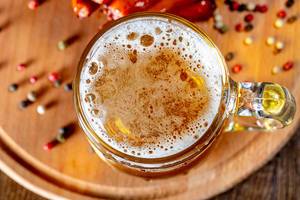 Top view a glass of beer on a wooden Board with spices (Flip 2019)