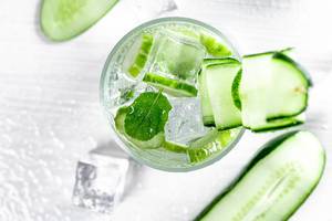 Top view cooling cucumber drink with ice cubes