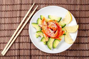 Top view, diet salad with smoked salmon, avocado and sesame seeds (Flip 2020)