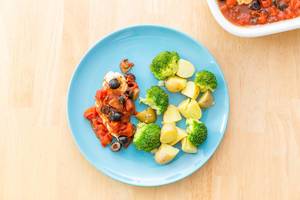 Top View Food Photo of Grilled Chicken with Olive-Tomato Sauce, Broccoli and Potatoes