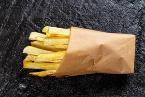 Top view French fries on black background (Flip 2019)