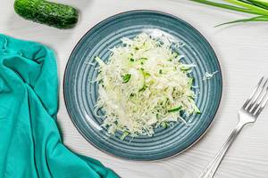 Top view fresh coleslaw in plate on white wooden background with fork (Flip 2019)