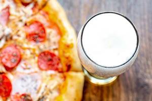 Top-view-glass-of-light-beer-and-pizza-on-wooden-background.jpg