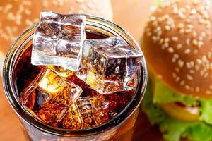Top view ice cubes in a glass with a drink and burgers (Flip 2019)