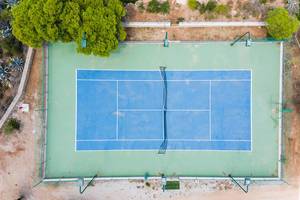 Top view of a blue and green tennis court on the greek island Spetses