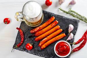 Top view of a light beer with spices and grilled sausages (Flip 2019)
